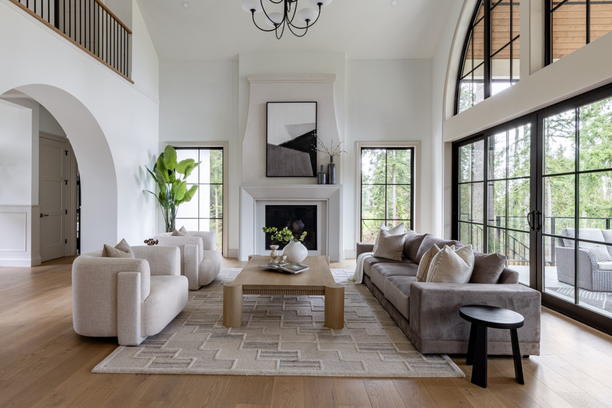 Vaulted great room with a fireplace, arched windows, and soft modern finishes in Plan 270109AF